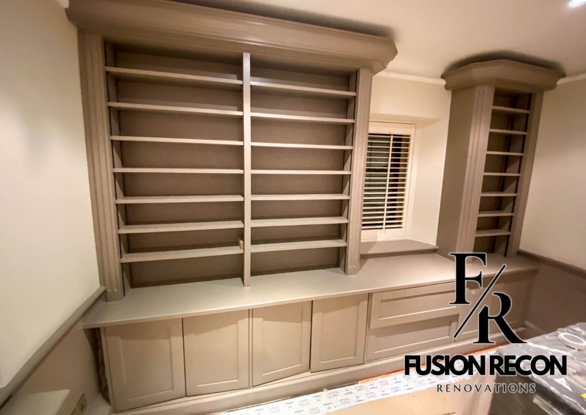 Custom library design in Kensington W8 with bespoke shelving and elegant wood finish.