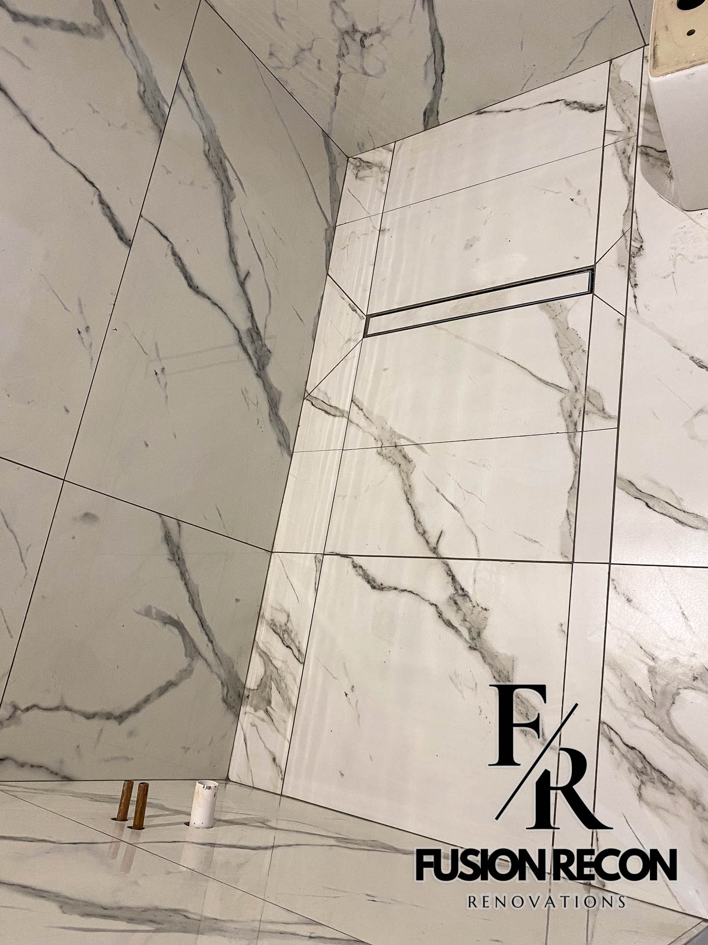 Custom wetroom design with marble tiles and frameless glass – Balham SW12