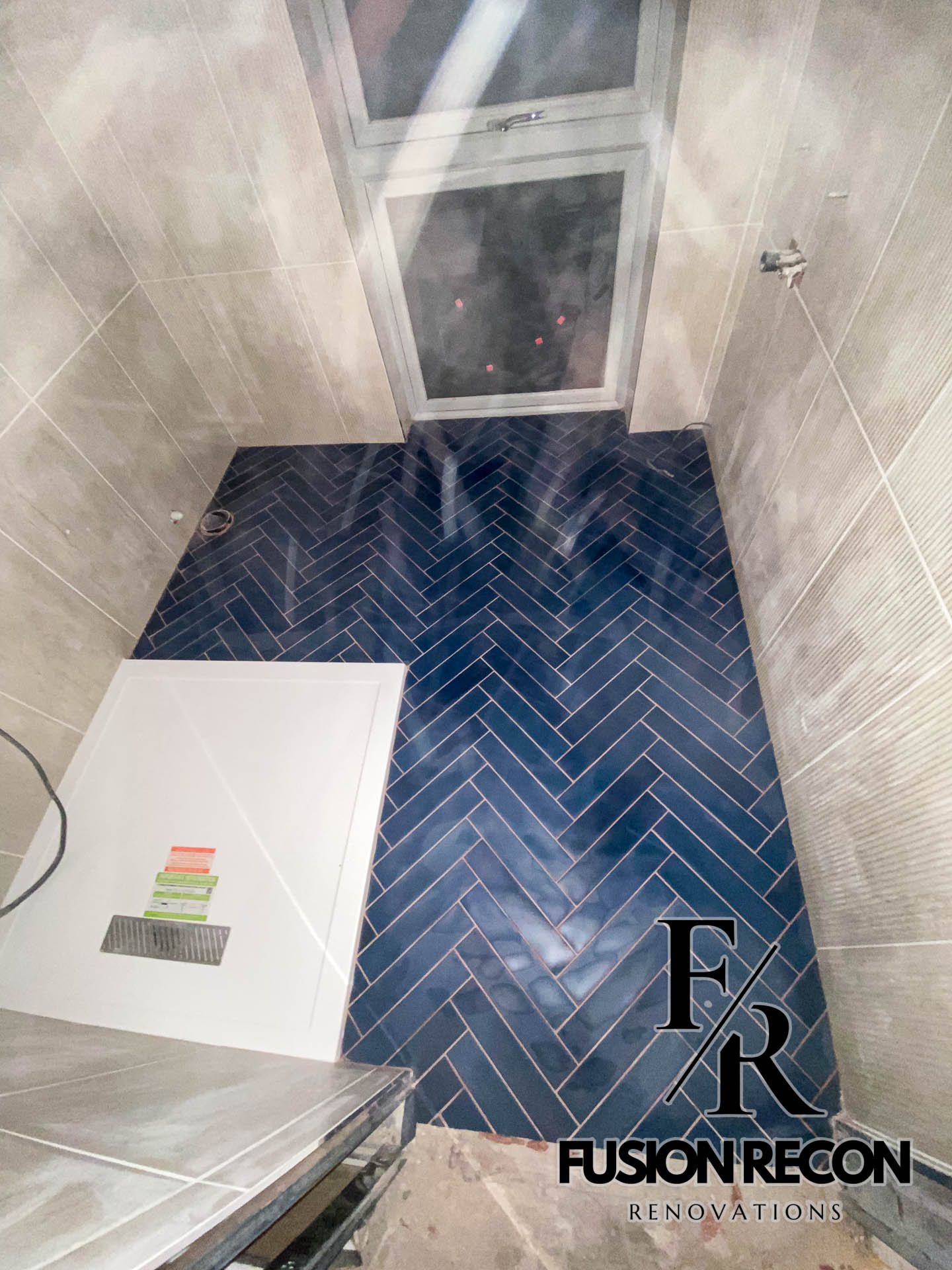 Bathroom renovation with herringbone flooring and metro tiles – South Kensington SW7